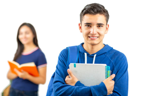 Young and happy latin students studying standing on white background. Young man looking at the camera