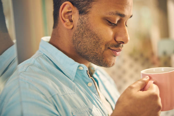 istock Close up of relaxed man going to drink tea 1263689272