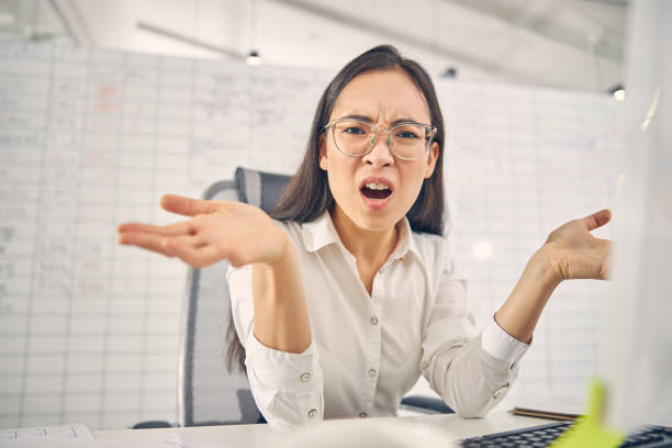istock Close up of emotional female during working process 1263689358
