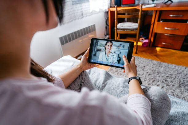 istock Practicing physician having online meeting with a patient 1263690323