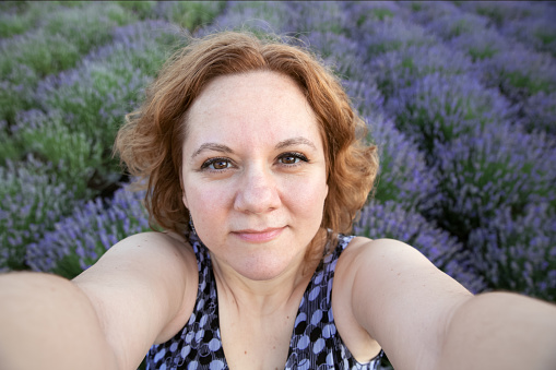 Pretty woman in lavender field looking at camera