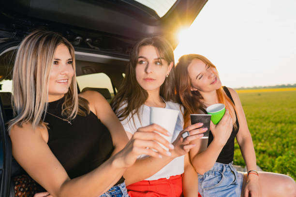istock Girls have coffee break at car trunk 1263693413