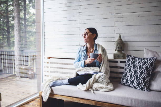 istock Woman sitting comfortable and looking through the window 1263694666
