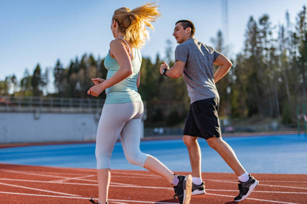 istock Young couple running at tartan. 1263697229