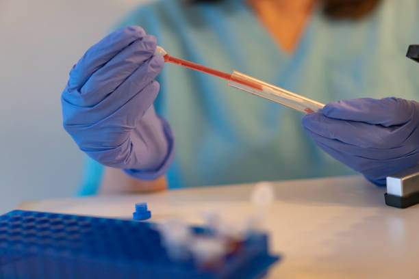 istock Latin american lab techniciab wearing protective gloves working with a patient's  swab 1263697246