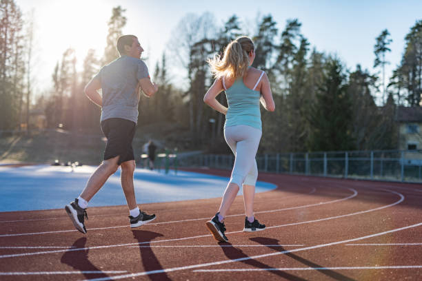 istock Young couple running at tartan. 1263697282