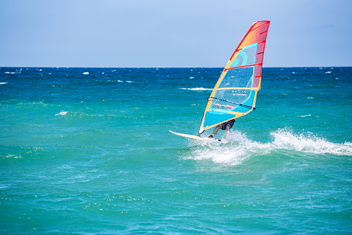 Pomorie, Burgas / Bulgaria -08.01.2020:Man athlete rides the windsurf over the waves on sea