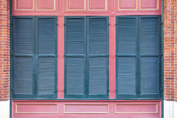 Shuttered windows surrounded by a typical New Orleans style of architectural detail