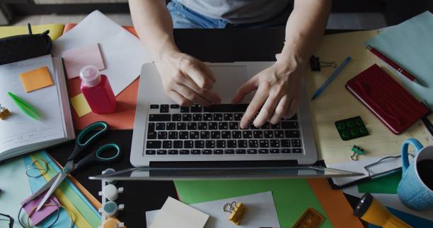 istock Hands of a woman doing office work at home 1263698274
