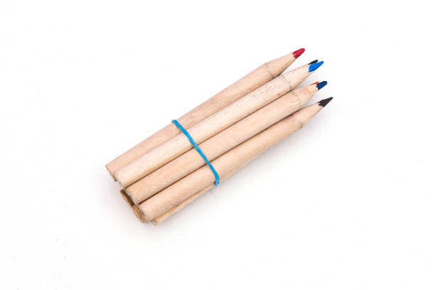 istock Multi-colored pencils held together with an elastic band, isolated on a white background with a copy of the space. 1263698510