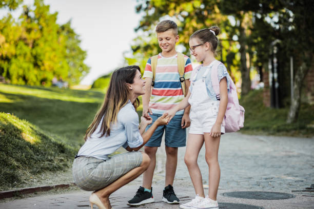 istock Mother accompanies children to school 1263699371