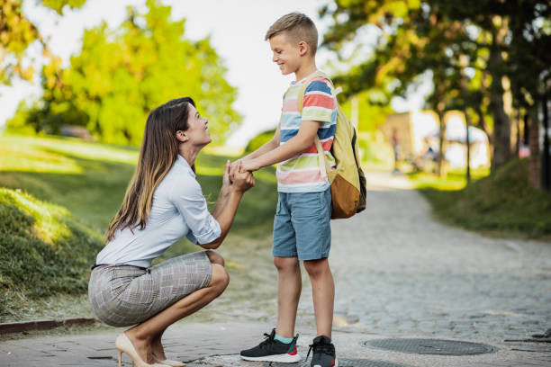 istock Mother accompanies her son to school 1263699389