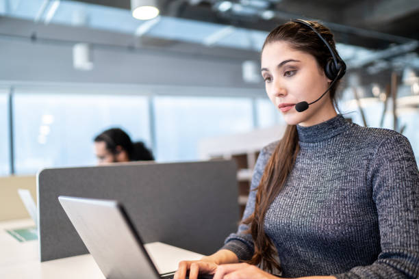 istock Businesswoman wearing headset and talking to client 1263699593