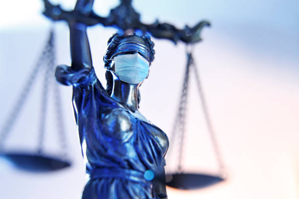 Lady Justice Wearing A Protective Face Mask A close up of the the lady justice photographed from a very low camera angle wearing a protective face mask. lady justice photos stock pictures, royalty-free photos & images