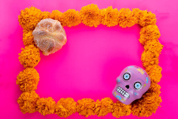 istock Composition with typical Mexican skull and cempazuchitl flowers on bright pink background. 1263700968