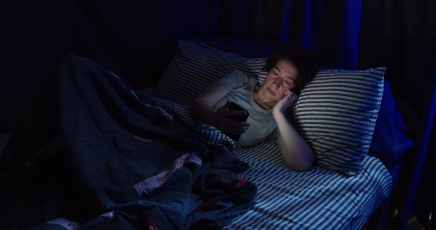 istock Woman is using smart phone in bed 1263704004