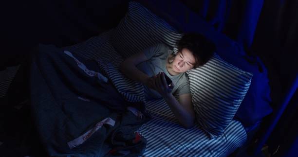 istock Woman is using smart phone in bed 1263704011