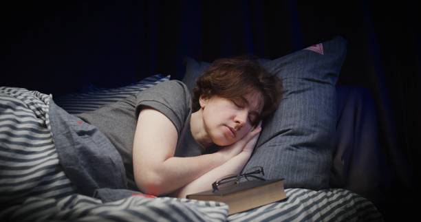 istock Woman is sleeping after reading paper book in bed 1263704775