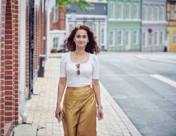 istock Beautiful woman walking on pavement 1263705030