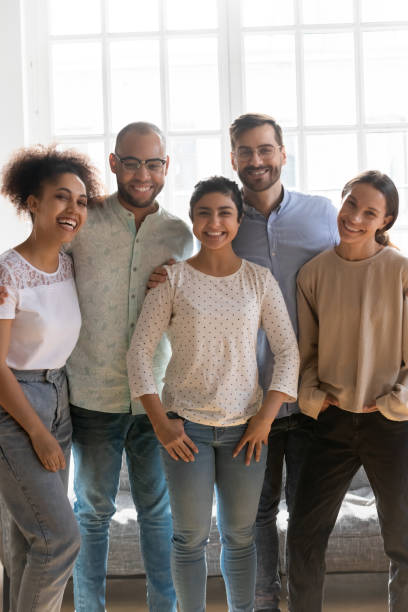 istock Vertical view five multi-ethnic best friends posing indoors 1263705771