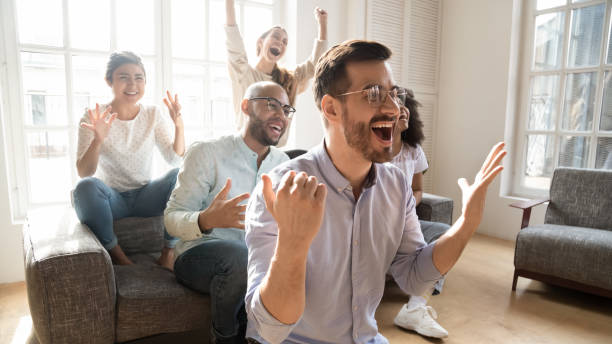 istock Excited multicultural friends watching on tv sport game feels euphoric 1263705779