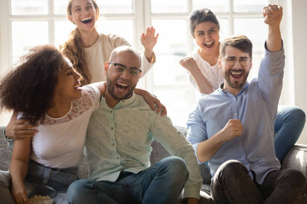 istock Excited overjoyed friends shouting with joy celebrating sport team win 1263705782