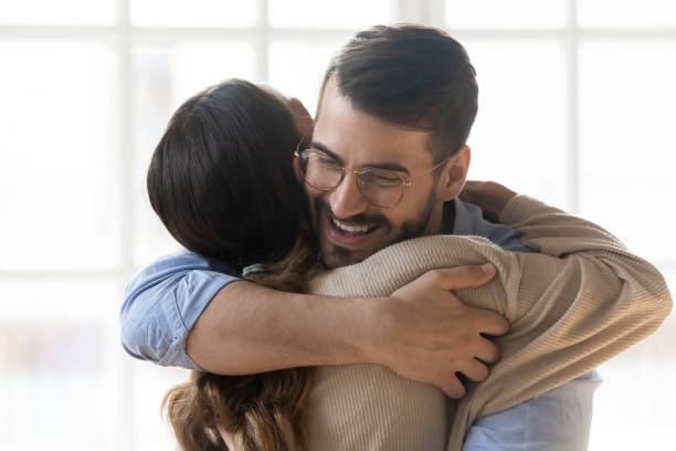 istock Smiling couple embracing glad to see each other 1263705785