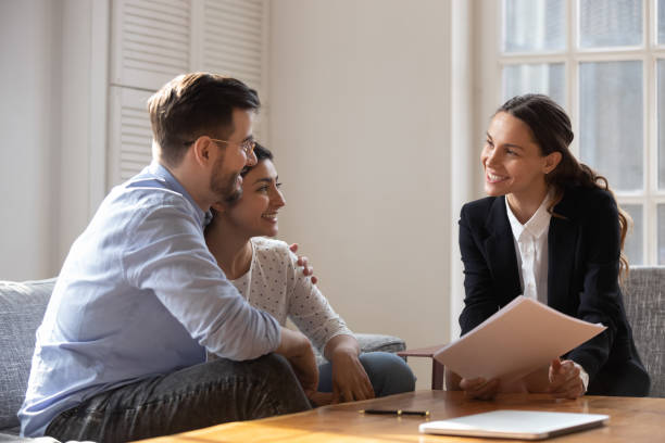 istock Client and banker seated on sofa discuss mortgage contract terms 1263705796