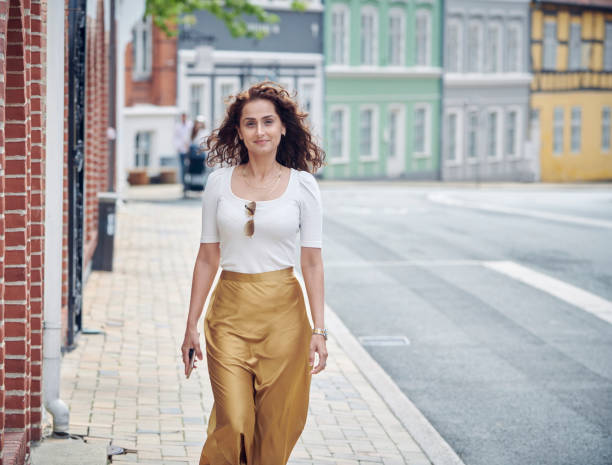 istock Beautiful woman walking on pavement 1263705808