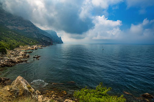 Sea and mountains in the clouds. Beautiful sea natural landscape, travel.