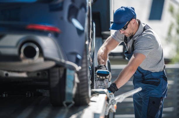 istock Towing Company Worker Securing Vehicle on the Truck Platform 1263706774
