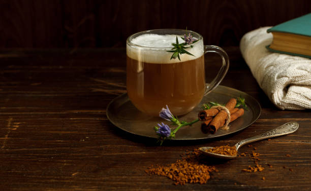 Coffee with milk foam from chicory root on a dark wooden background, horizontal orientation with space stock photo