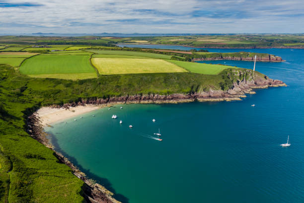 Aerial view of a small sandy bay in Wales Aerial view of a small, sandy beach in a rocky bay (Watwick Bay, Milford Haven, Wales) milford haven stock pictures, royalty-free photos & images