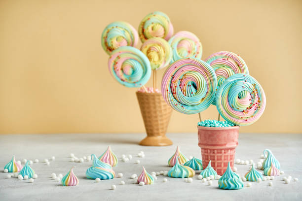 istock Meringue lollipop on yellow background. Closeup 1263710105