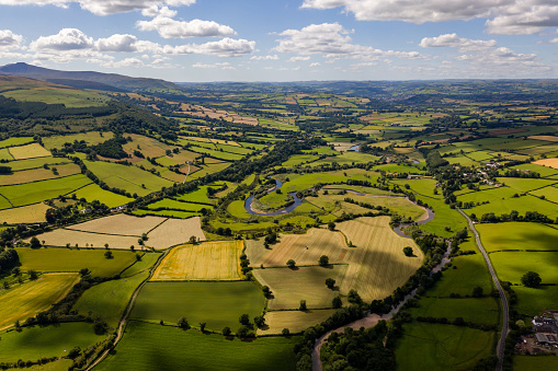Aerial view of greenfields and farmland in a beautiful rural area (Brecon Beacons, Wales, UK)