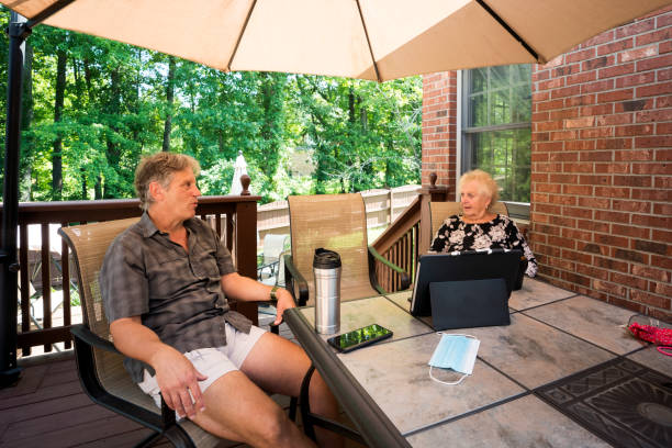 istock Social distancing outdoors under an umbrella 1263712566
