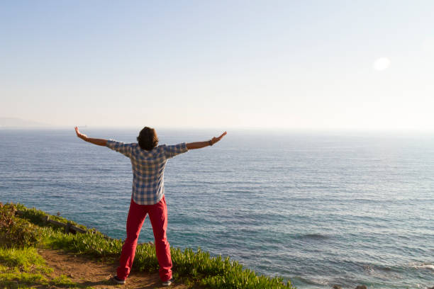 istock Young man feel freedom at the beach 1263716455