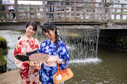 Mother and daughter in yukata visiting local village for sight seeing