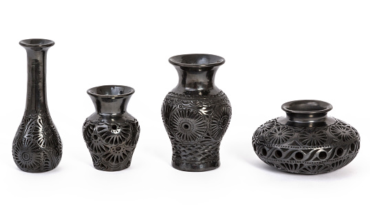 Black clay vases, typical Mexican crafts on white background.
