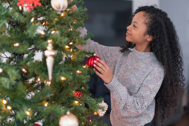 istock A young girl decorates the Christmas tree 1263722983