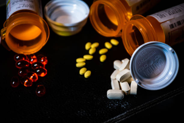 istock open Pill Bottles and capsules ready to take medicine 1263731211