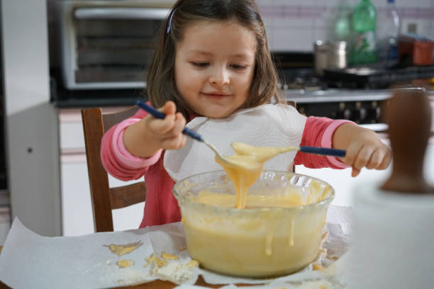 istock Beautiful little girl cooking during quarantine 1263732346