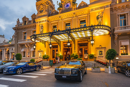 Casino Monte-Carlo in the night, hotel de Paris, night illumination, luxury cars, players, tourists, fountain, cafe de paris. Monaco, Monaco - July 29 2016.