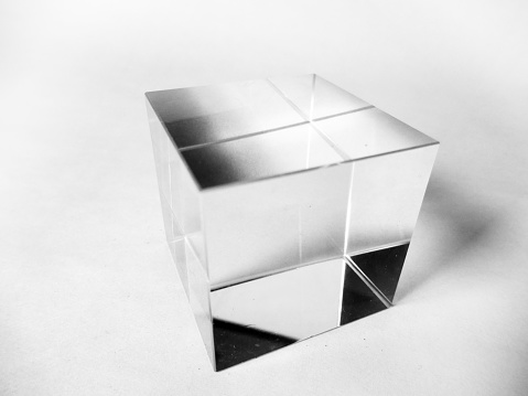 A 3D metal object, levitating above the ground. With a white background. Abstract 3D computer render.