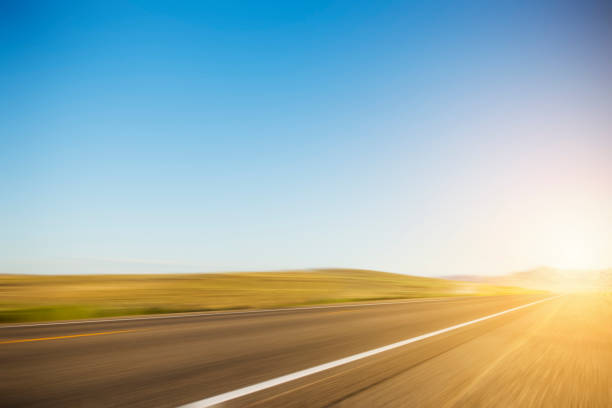 istock Speeding on Highway with Sunrise Background 1263747952