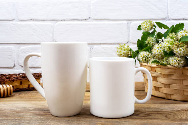 istock White coffee and cappuccino mug mockup with white spirea 1263749301