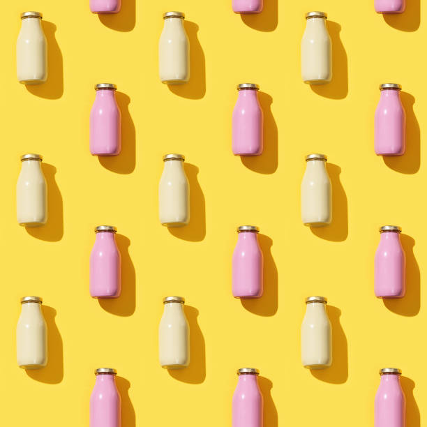 istock Creative seamless pattern with small glass bottles for juice with hard light. 1263755060