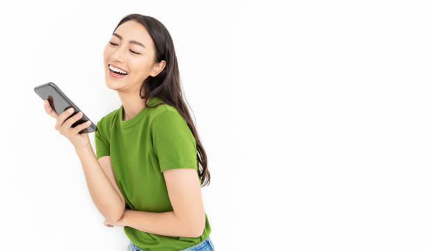 portrait of beautiful asian japanese successful business girl celebrate with smartphone with copy space on white background. success and happy woman education internet technology startup business concept - japanese ethnicity women asian and indian ethnicities smiling imagens e fotografias de stock