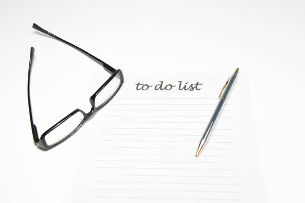 Things to do list with spectacles and pen List of things to do placed on a study table along with a pair of glasses and a pen sabby stock pictures, royalty-free photos & images