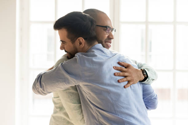 istock African and Caucasian guys hugging glad to see each other 1263756251